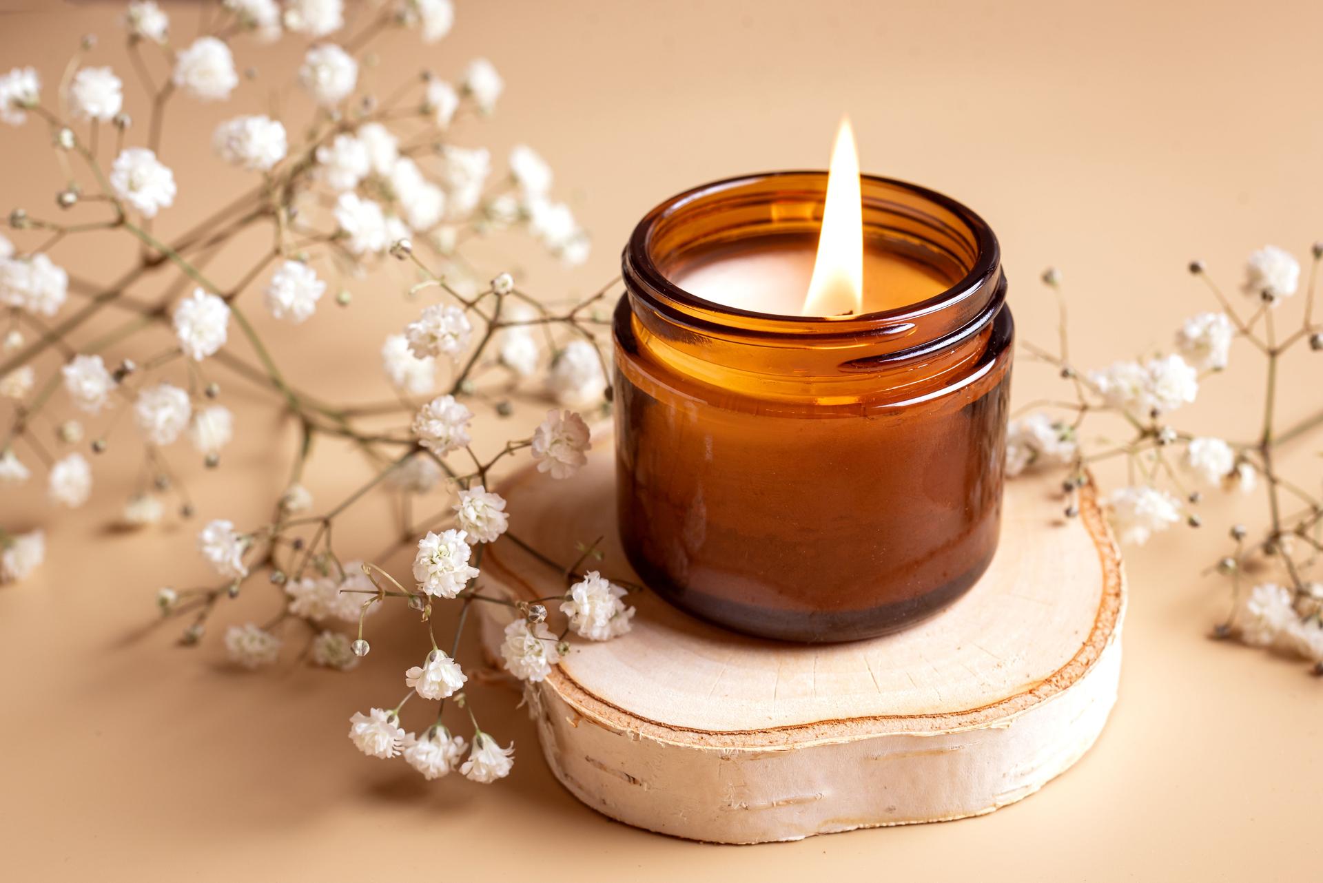 Scented candle and white gypsophila flowers